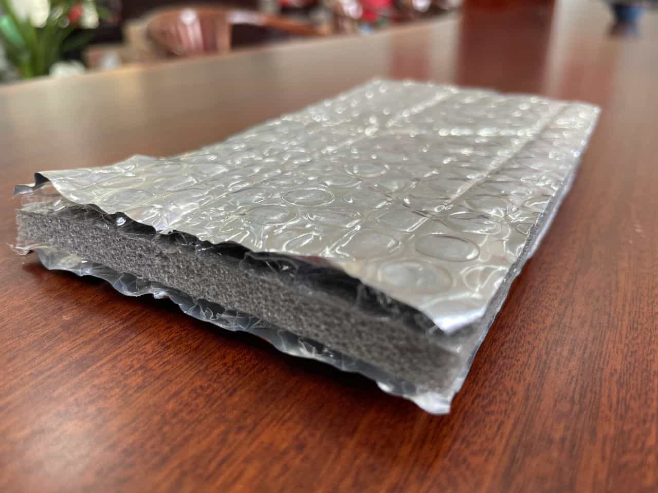 High-quality thermal insulation material with layered bubble wrap and foam core, designed for temperature control and energy efficiency in residential and commercial buildings.